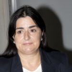 zervaki_anna_1 Brunette woman looking away from the camera with black blazer and white shirt