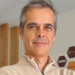 Luis Pereira Man smiling to the camera in a jumper